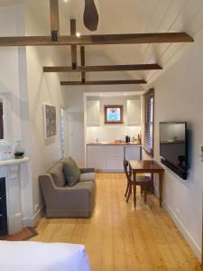 a living room with a couch and a table at Bon Accord in Sale