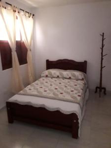 a bedroom with a bed in a room with a window at Hostal la Lomita in Popayan