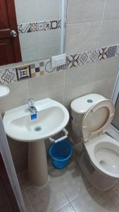 a bathroom with a toilet and a sink at Hostal la Lomita in Popayan