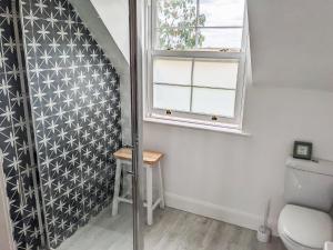 a bathroom with a toilet and a window at Stonebank House in Lamberton