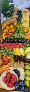 a tray filled with different types of fruits and vegetables at Ugostiteljski objekat KARIBO in Sombor