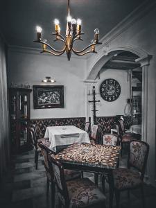 a dining room with a table and chairs and a clock at Ugostiteljski objekat KARIBO in Sombor