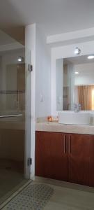 a bathroom with a tub and a sink and a mirror at Hotel RRU Puebla in Puebla