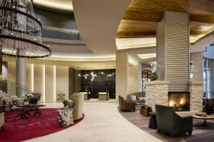 a lobby with a fireplace and a chandelier at Archer Hotel Austin in Austin