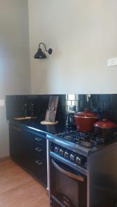 a kitchen with a stove with pots and pans on it at Casa con pileta en Paso de la Patria in Paso de la Patria