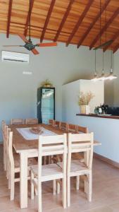 a dining room with a wooden table and chairs at Casa con pileta en Paso de la Patria in Paso de la Patria