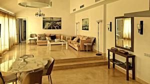 a living room with a couch and a table at 3 bedroom Penthouse in Sotogrande Puerto Deportivo in Sotogrande