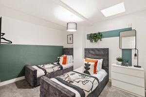 a living room with two beds and a couch at Elegant Flat - Sleeps 8 in Bristol