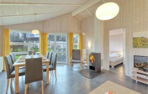 a dining room with a table and a fireplace at Strandpark 6 in Schönhagen