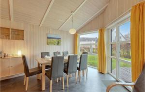 a dining room with a table and chairs at Strandpark 6 in Schönhagen