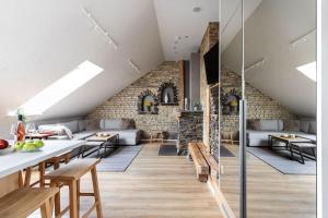 a living room with tables and a brick wall at Luxury apartment in Gediminas avenue with terrace in Vilnius