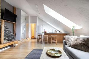 a living room with a couch and a table at Luxury apartment in Gediminas avenue with terrace in Vilnius