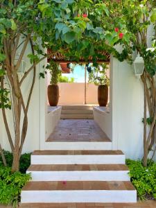 a hallway with stairs with trees and plants at Villa Canziani & Donato in Pôrto de Pedras