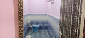 a bathroom with a blue toilet in a room at Govind Niwas Homestay in Jagdalpur +44 photos