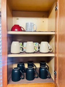 a cupboard filled with lots of pots and pans at Spacious single family home close to VA and DC 5mins to MGM in Fort Washington
