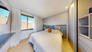 a bedroom with a bed and a large window at Liniers Green Apartments in Chacras de Coria