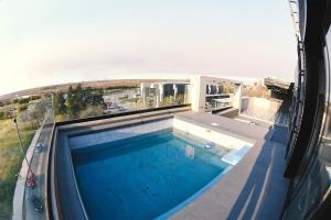 a swimming pool on top of a building at Depto. en Costanera frente al rio 2 a 4 personas in San Nicolás de los Arroyos