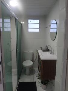 a bathroom with a toilet and a sink and a shower at Real Hospedagem in Manaus