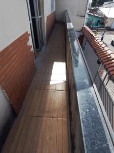 an empty hallway with a wooden floor and a window at Real Hospedagem in Manaus