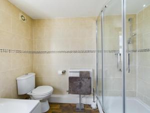 a bathroom with a toilet and a shower at Modern 5 Bedroom House Near Lark Lane in Liverpool