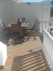 a patio with chairs and a table on a balcony at Villa Castro Marim in Castro Marim