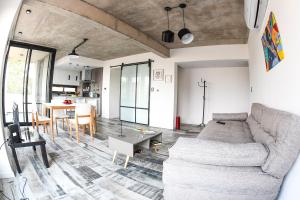 a living room with a couch and a table at Depto. en Costanera frente al rio 2 a 4 personas in San Nicolás de los Arroyos