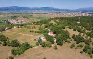 an aerial view of a small village on a hill with trees at 4 Bedroom Cozy Home In Otok in Otok +25 photos