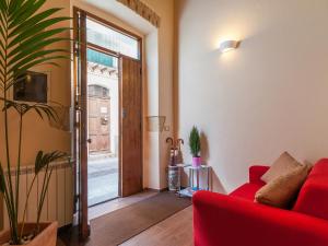 a living room with a red couch and a sliding glass door at Il Borgo in Cagliari