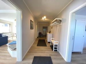 a hallway leading to a living room with a staircase at Reethaus Vilmnitz Reethaus Vilmnitz - Fewo "Muglitz" in Vilmnitz