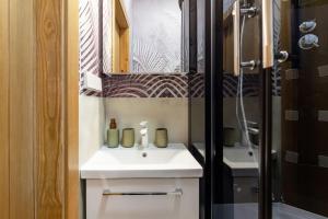 a bathroom with a white sink and a shower at Luxury apartment in Gedimino av. in Vilnius +34 photos