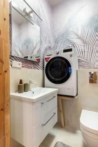 a bathroom with a washing machine on the wall at Luxury apartment in Gedimino av. in Vilnius