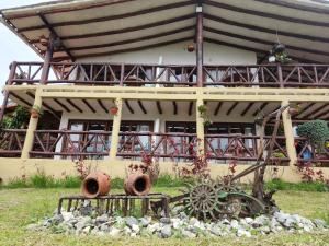 a house with a wheel sculpture in front of it at Akawanka Lodge in San Agustín