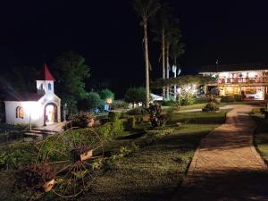 a church and a garden at night with a wheel at Akawanka Lodge in San Agustín