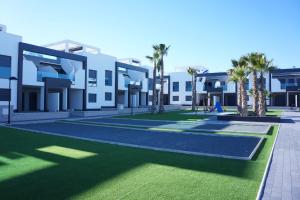 a rendering of the courtyard of a building with palm trees at Apartment Oasis Beach La Zenia in Playas de Orihuela