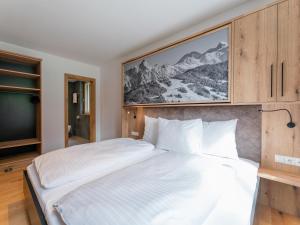 a bedroom with a large bed and a tv at Schmittenblick 2 in Viehhofen
