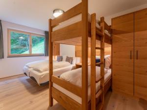 a bedroom with two bunk beds and a window at Schmittenblick 3 in Viehhofen