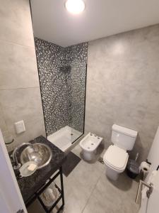 a bathroom with a toilet and a sink and a shower at Departamento - Salta Capital cg - Edificio Usina in Salta