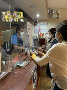 a woman wearing a mask at a counter in a store at Hotel Acuario in Churín