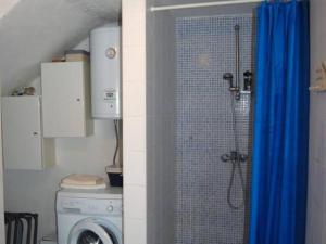 a bathroom with a shower and a washing machine at Seaside holiday house Lukoran, Ugljan - 20384 in Lukoran