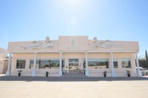 a building with two statues on the front of it at Hotel Santorian in Hermosillo