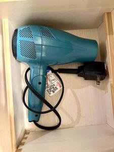 a blue blow dryer hanging from a wall at Beautiful, well-stocked home - sleeps 7! in Yakima