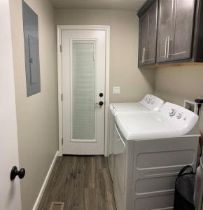 a bathroom with a sink and a washing machine at Beautiful, well-stocked home - sleeps 7! in Yakima