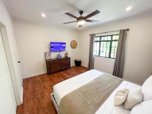 a bedroom with a bed and a ceiling fan at Westend House Newly Renovated 3 Bedroom in Petit Valley