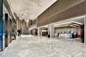 een lobby met een trap in een gebouw bij Yiwu Yandoo Yayue Hotel in Yiwu