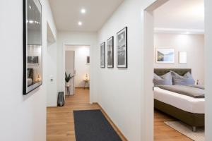 a bedroom with white walls and a bed and a hallway at MH Living - 23 - Scandinavian Living Dream in Center in Graz