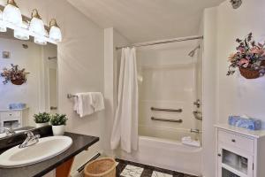 a white bathroom with a shower and a sink at The Birch Ridge- American Classic Room #7 - King Suite in Killington, Hot Tub, home in Killington