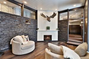 a living room with two chairs and a fireplace at One-Bedroom House in Killington
