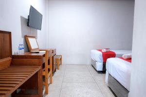 Tempat tidur dalam kamar di Capital O 93602 Hotel Tempoa Inn