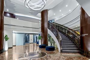 a spiral staircase in a building with a lobby at Peppers Waymouth Hotel in Adelaide