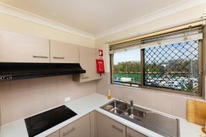 a kitchen with a sink and a window at Braemar 6 in Forster